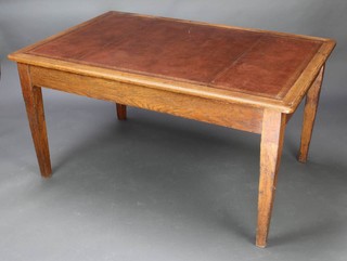A Victorian rectangular oak library table with inset brown writing surface, raised on square tapered supports 71cm h x 137cm w x 90cm d 