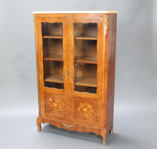 A French kingwood bookcase/display cabinet with pink veined marble top, fitted adjustable shelves enclosed by panelled doors and with gilt metal mounts 161cm h x 100cm w x 38cm d 
