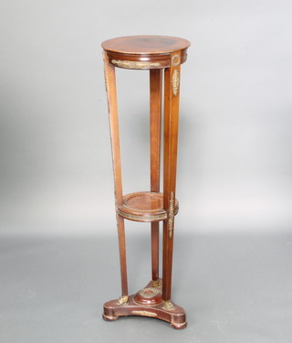 A circular mahogany Empire 3 tier jardiniere stand, the circular 2 tiers with brass embellishment raised on a tripod base 98cm h x 29cm 