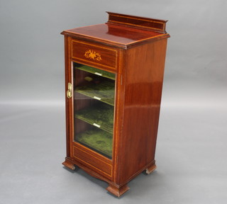 An Edwardian inlaid mahogany music cabinet with raised and crossbanded top, with plush interior enclosed by glazed panelled doors on ogee bracket feet 100cm x 48cm x 40cm 
