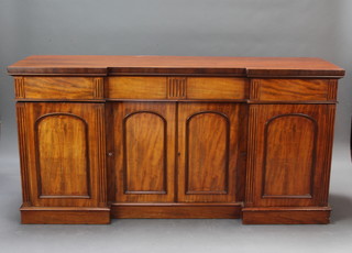A Victorian mahogany inverted breakfront sideboard fitted 1 long drawer flanked by 2 short drawers above a double cupboard enclosed by arched panelled doors flanked by a pair of cupboards enclosed by panelled doors and raised on a platform base 91cm h x 183cm w x 55cm d  