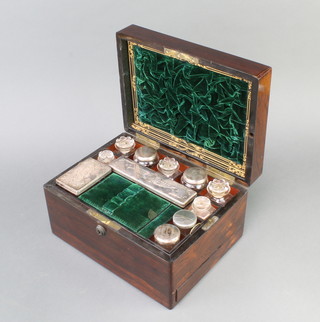 A Victorian rectangular rosewood vanity box with hinged lid, having a fitted interior with cut glass bottles and silver plated mounts 17cm h x 30cm w x 22cm d 