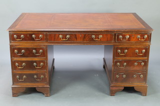 A Georgian style mahogany kneehole pedestal desk with inset tooled leather writing surface above 1 long and 8 short drawers, raised on bracket feet 76cm h x 153cm w x 90cm d 
