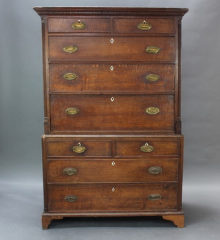 A George III oak secretaire chest on chest with moulded and dentil cornice and reeded columns to the sides, fitted 2 short and 2 long drawers with secretaire drawer, the base with 2 short and 2 long drawers with ivory escutcheons and oval brass plate drop handles, raised on bracket feet 177cm h x 188cm w x 55cm d