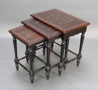 A nest of 3 ebonised and embossed leather interfitting coffee tables, the tops with Inca style decoration, raised on turned supports 62cm h x 59cm w x 42cm d,  59cm x 50cm x 38cm, 55cm x 40cm x 33cm  