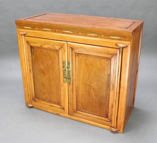 A Chinese light padauk cabinet, fitted shelves and 2 drawers enclosed by a pair of panelled doors 90cm h x 104cm w x 48cm 