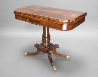A William IV rosewood card table, raised on a turned column with tripod base, brass caps and casters 74cm h x 91cm w x 45cm d 