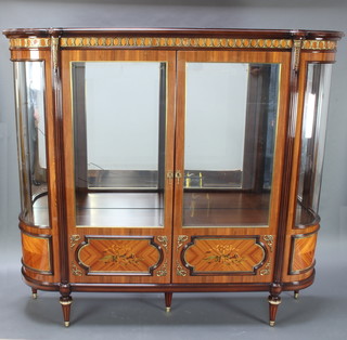An impressive Kingwood D shaped display cabinet with gilt metal mounts and reeded columns to the sides, mirrored back, enclosed by panelled doors decorated musical trophies 178cm h x 192cm w x 43cm d 