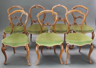 A harlequin set of 7 Victorian mahogany balloon back dining chairs with pierced mid rails (made up of a set of 5 and 2 singles) 