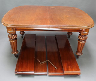 A Victorian mahogany extending dining table with 4 extra leaves, raised on turned and reeded supports 75cm h x 123cm w x 152cm l x 301cm when extended 