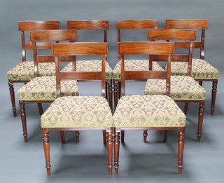 A set of 8 Georgian mahogany bar back dining chairs with ebonised stringing, plain mid rails and upholstered seats, raised on turned supports 