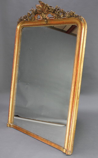 A 19th Century arched plate wall mirror contained in a decorative gilt frame surmounted by a shell shaped crest 174cm x 121cm 
