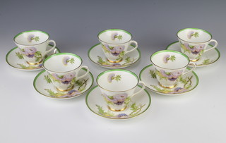 A Royal Doulton part tea set decorated with thistles by P Curnock comprising 6 tea cups and 6 saucers