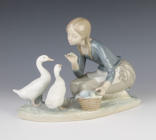 A Lladro group of a girl feeding 2 geese from a basket of vegetables 4849 23cm 
