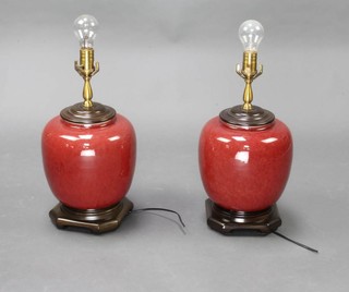 A pair of Chinese Sang de Beouf style baluster vase table lamps with hardwood mounts 30cm 