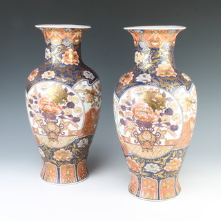 A pair of 20th Century Imari baluster vases decorated with panels of flowers and birds 40cm 