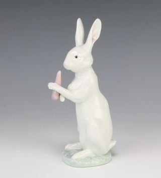 A Lladro rabbit holding a carrot 588 17cm