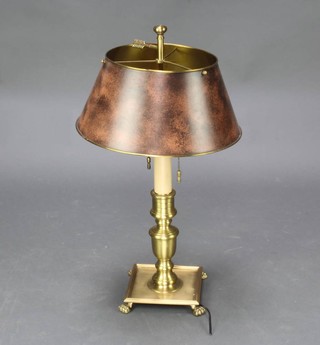 A 19th Century style gilt and pressed metal table lamp raised on a square base with hoof feet 23cm h, the shade 34cm diam. 