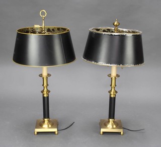 A pair of gilt and black polished metal table lamps with shades, raised on square bases with bun feet, 72cm h x 14cm x 14cm  
