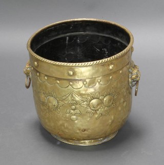 A cylindrical embossed brass twin handled jardiniere/coal bin with lion mask handles 37cm h x 36cm diam, 