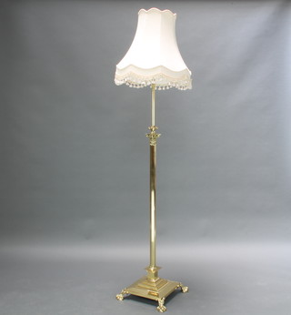 A Victorian style brass finished adjustable standard lamp with Corinthian capital, reeded column, raised on a square base with paw feet 114cm h x 36cm w x 37cm d   