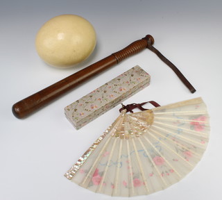 An ostrich egg, a turned wooden Police truncheon 41cm (split to the body) and a mother of pearl and fabric fan (1 stick f) 