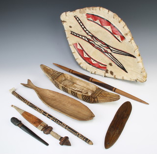 An African oval shield 51cm x 30cm, an African double edge dagger with 18cm blade and 4 other ethnic items 