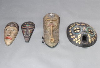 Two Ghana wall masks insets beads and brassware 36cm diam. and 31cm x 16.5cm, and 1 other mask labelled to the reverse Tuki Mask Tongo 