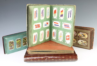 Four albums of cigarette cards including players and an album of postcards