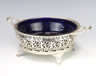 A silver bowl holder with pierced floral decoration on scroll feet Birmingham 1925, 416 grams, 25cm, maker Adie Brothers with blue glass liner