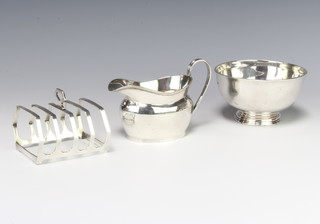 A silver pedestal bowl Sheffield 1911, a 5 bar toast rack and a cream jug, 259 grams 