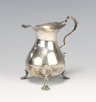 A Georgian design silver cream jug on hoof feet with S scroll handle Birmingham 1947, 88 grams, 9cm 