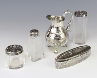 An Edwardian oval cut glass and silver mounted toilet jar, 3 others and a plated cream jug 
