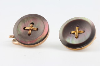 A pair of 9ct yellow gold mother of pearl dress studs in the form of buttons