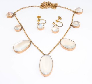A 9ct yellow gold necklace with 7 cabochon cut moonstones and a pair of ensuite earrings 