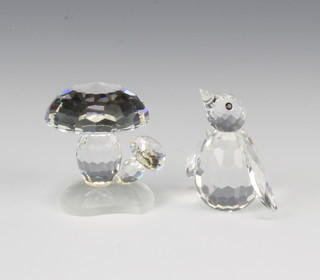 A Swarovski Crystal Toadstools by Adi Stocker 119206/7472030000 1989, 3cm together with a penguin by Max Schreck 010027/7661033000 1985 boxed 3 cm 