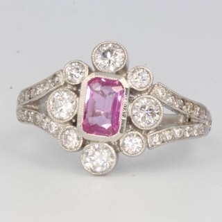 A platinum pink sapphire and diamond cluster ring, size N 