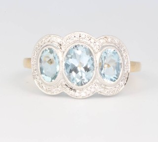An 18ct yellow gold aquamarine and diamond triple cluster ring size M 1/2