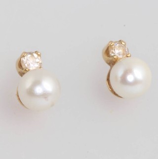 A pair of 18ct yellow gold pearl and diamond ear studs 