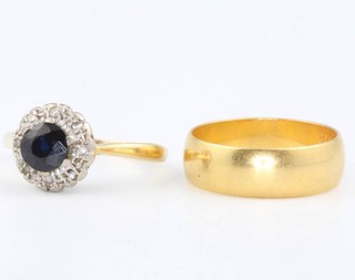A 22ct yellow gold wedding band size K 4 grams and an 18ct sapphire and diamond cluster ring size J