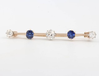 A yellow gold bar brooch set with 3 brilliant cut diamonds and 2 brilliant cut sapphires, the diamonds 0.15, 0.15 and 0.30ct, the sapphires each approx. 0.25ct, 45mm