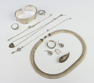 A silver bangle and minor silver jewellery, 100 grams