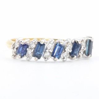 An 18ct yellow gold sapphire and diamond ring set with 6 baguette cut sapphires and 12 brilliant cut diamonds size S 