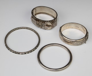 An Edwardian chased silver bangle and 3 others