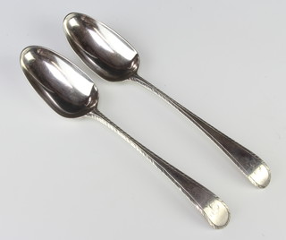 A pair of Georgian silver table spoons with bright cut decoration 84 grams 