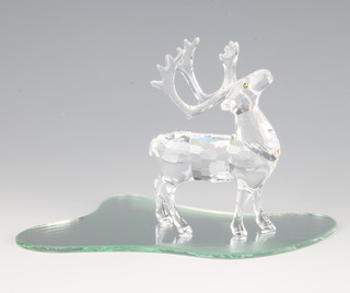 A Swarovski Crystal reindeer 214821/7475000602 1997 by Anton Hirzinger on stand, 9cm boxed 