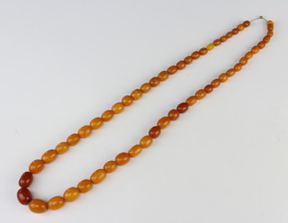 A string of amber honeycomb beads of mixed sizes, 50 grams