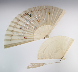 An Edwardian bone fan painted with flowers and butterflies, a composition do. 