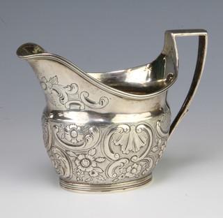 A George III repousse silver cream jug with scroll decoration London 1801, 150 grams 