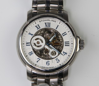 A gentleman's Stuhrling steel cased automatic wristwatch with visible movement on a steel bracelet with original box 